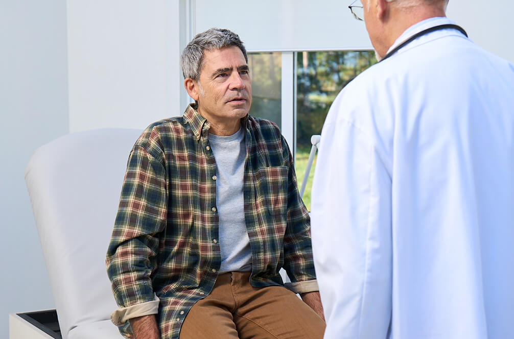 Actor portrayals of a man talking to a doctor